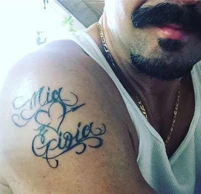 A picture of Max Casella showing the tattoo of his daughters' name.